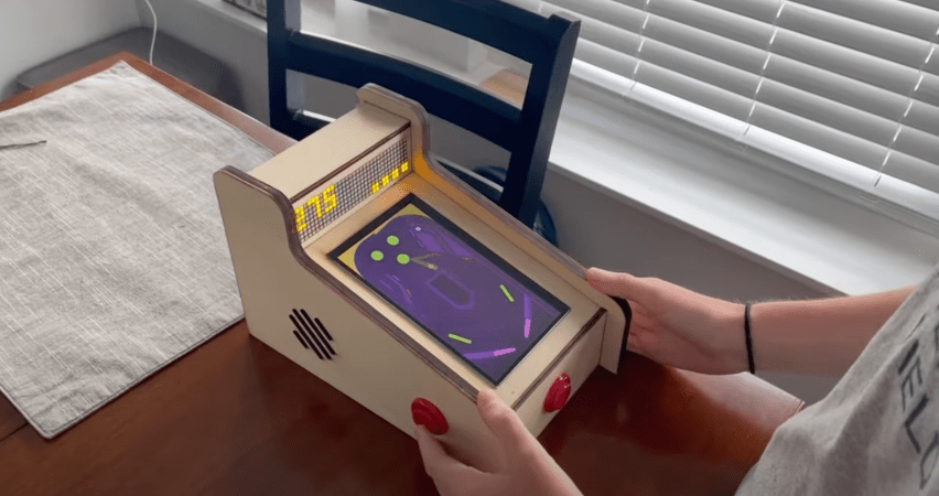 Chris playing his tiny pinball machine
