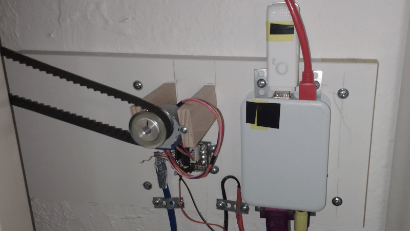 A Raspberry Pi in an enclosure, connected to a stepper motor controller and a UMTS stick