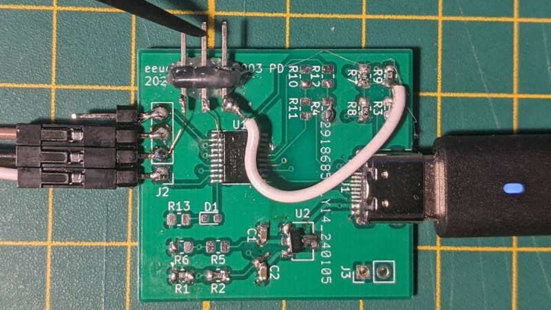 A devboard with the CH32V003, with a few resistors and bodges, with a USB-C cable plugged into it, and a programmer plus an extra probe attached.