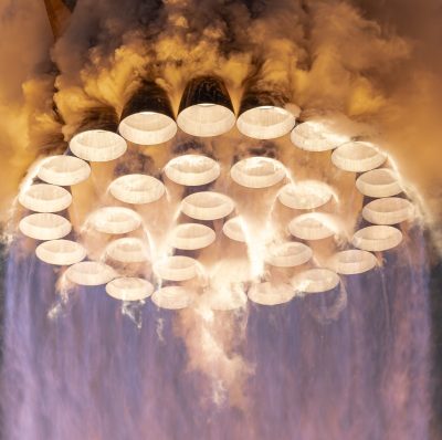 Space X Starship firing its many Raptor engines.